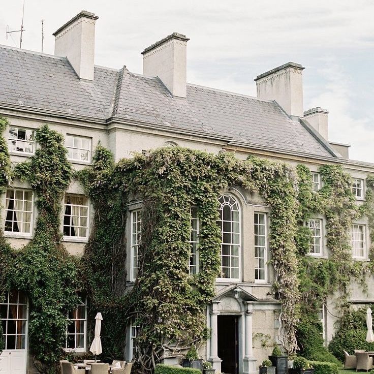 an old house with ivy growing all over it