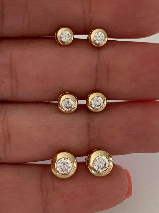 14K Yellow Gold Bezel Stud Earrings | Solitaire Earrings | Cubic Zirconia Studs | Dainty Bezel Studs | 5MM, 6MM, 7MM Shiny Everyday Earrings | Bezel Set Diamond Alike Earrings Studs | 14k Gold Earrings | 14K Gold Bezel Studs♦ Materials: 14K Gold♦ Available colors: Yellow Gold ♦ Closure: Push Back♦ Earrings Measurements: 5 MM, 6MM and 8MM. PLEASE REFER TO THE ACTUAL DIMENSIONS. WE HAVE ENLARGED THE PICTURES FOR A BETTER VIEW-------------------------------------------------- ♦ -------------------- Blink Blink, Solitaire Earrings, Gold Ring Designs, Tragus Earrings, Marvel Entertainment, Gold Bracelet For Women, Classic Earrings, Beaded Collar, Bezel Set Diamond