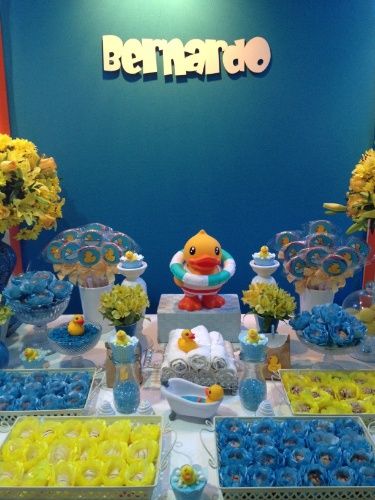 a table filled with blue and yellow desserts