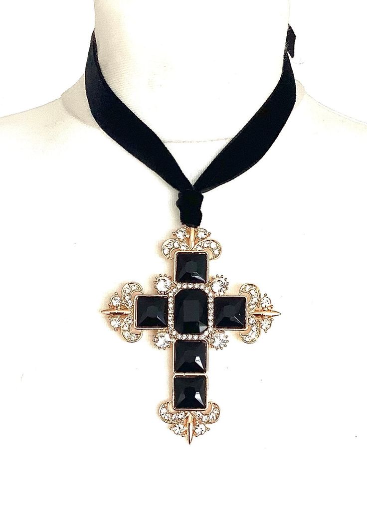 Black cross statement choker from Olivia Divine. Over-sized, black jewelled cross pendant. Set on a black velvet ribbon. Ties at the back, so can be worn as a choker or at a longr5 length. Cross 9 cm x 7 cm approx. Handmade deisgn. Elegant Cross Choker As A Gift, Cross Choker For Party, Adjustable Cross Jewelry For Party, Adjustable Black Cross Choker, Gothic Cross Pendant Jewelry For Party, Black Cross Choker Necklace, Black Cross Choker As Gift, Black Cross Pendant Necklaces For Party, Black Cross Pendant Necklace For Party