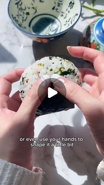 someone is holding a sushi in their hand