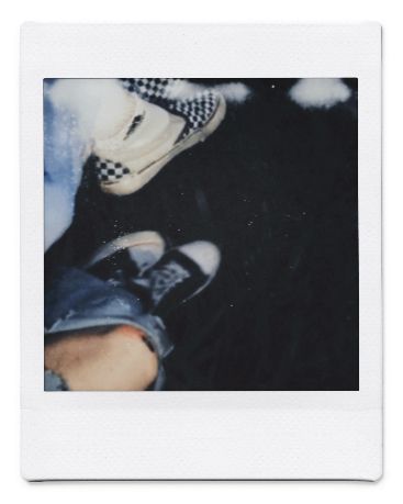 a polaroid photo of someone's feet and shoes