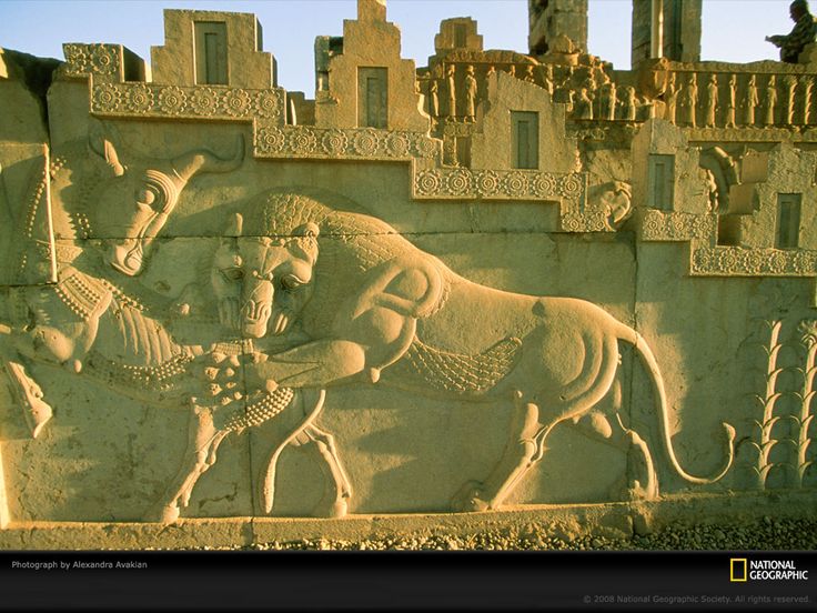 an intricately carved stone wall depicting two men and a horse in front of a castle