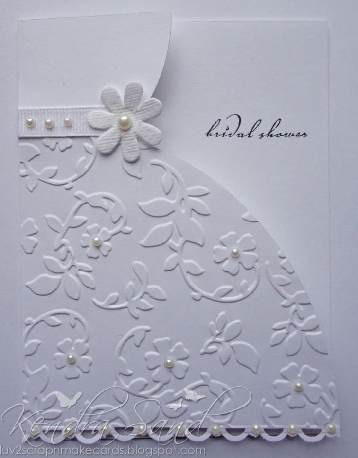 a white wedding card with flowers and pearls