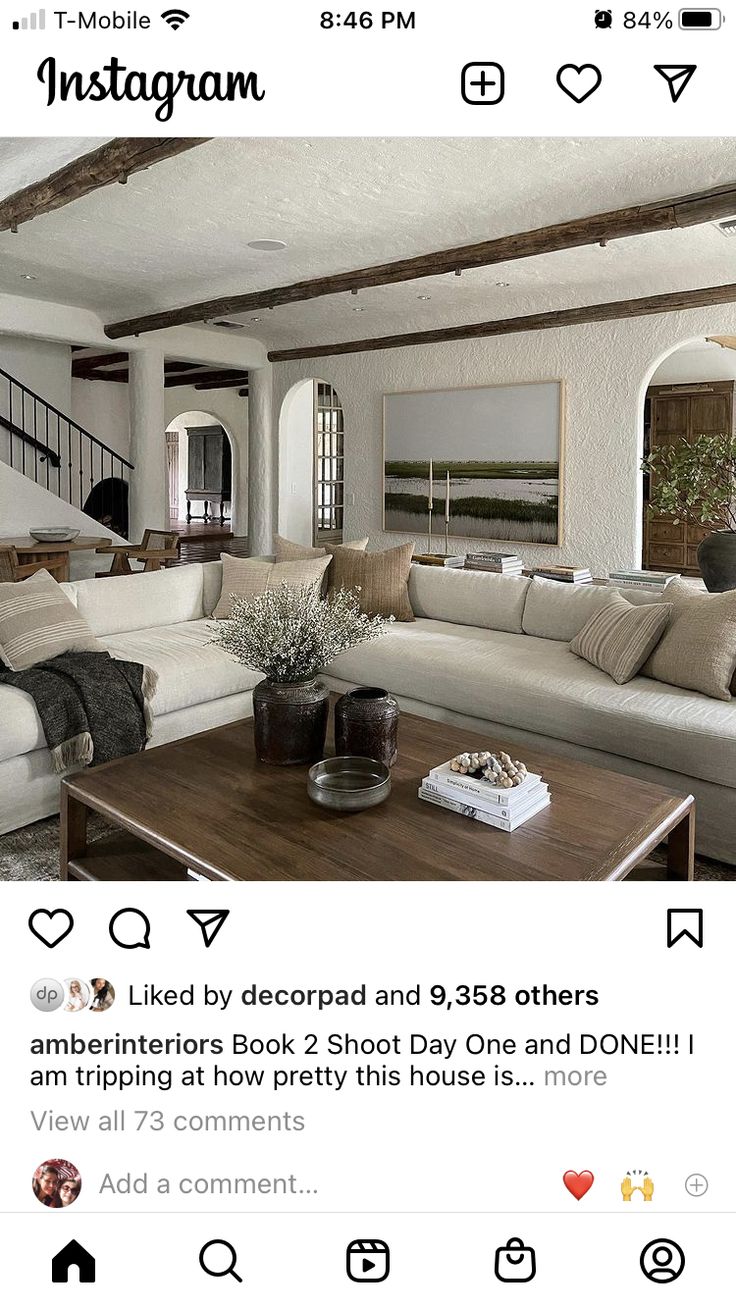 an instagram page with a couch, coffee table and stairs in the living room