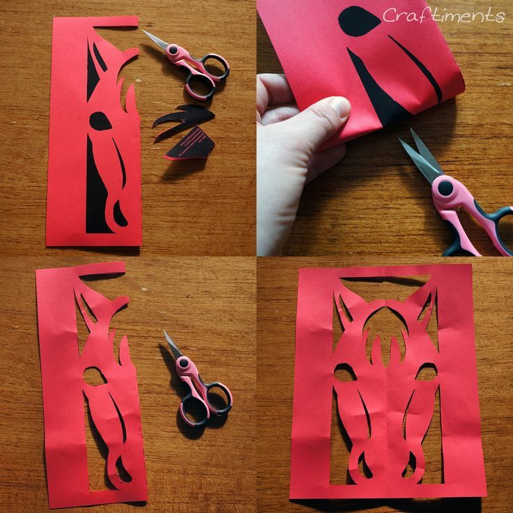 cut out pieces of red paper with scissors