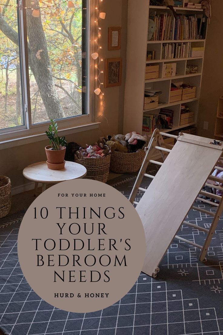 a bed room with a ladder next to a window and a book shelf filled with books