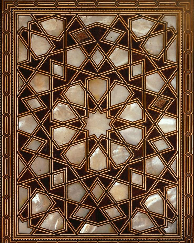 an intricately designed glass window in the shape of a star, with geometric designs