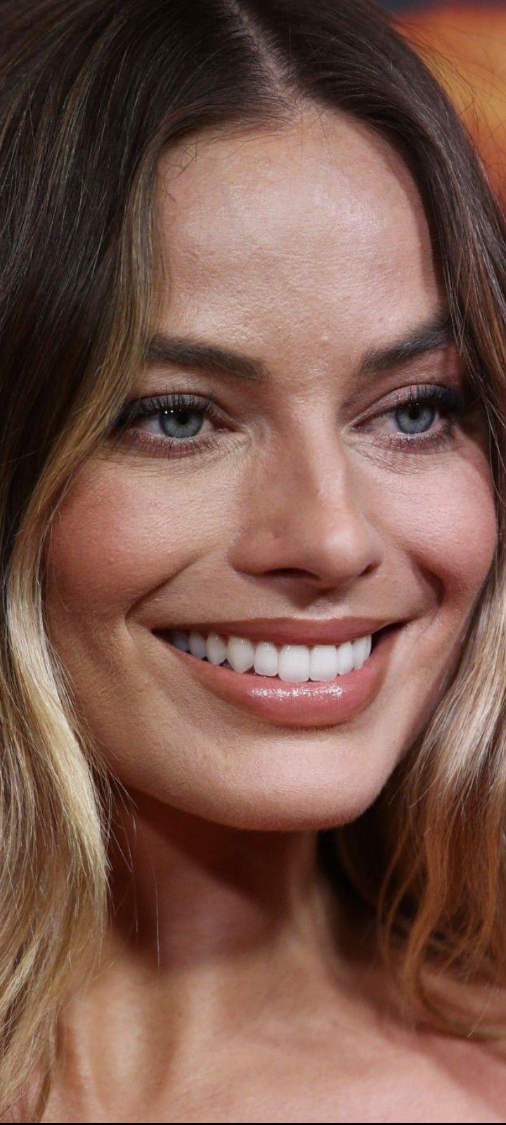 a close up of a woman smiling at the camera