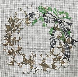 a cross stitched wreath with leaves and bows on the front, in white linen