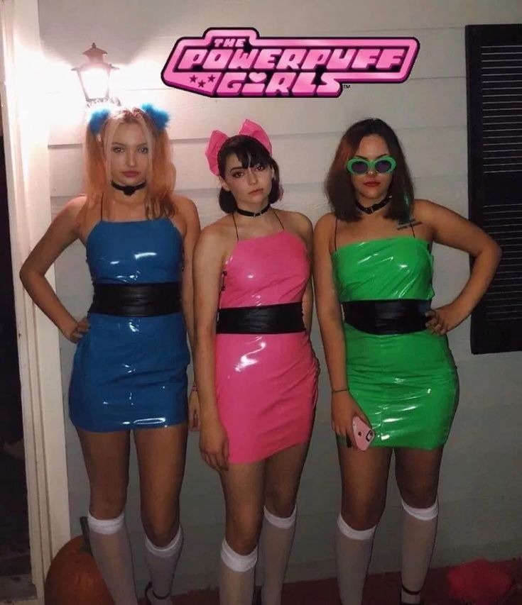 three women dressed up in costumes standing next to each other