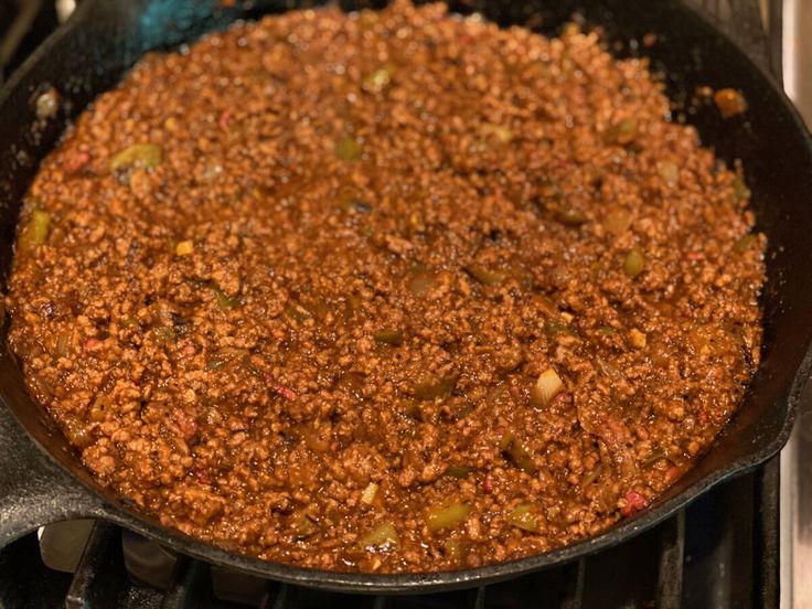 a skillet filled with food cooking on top of a stove