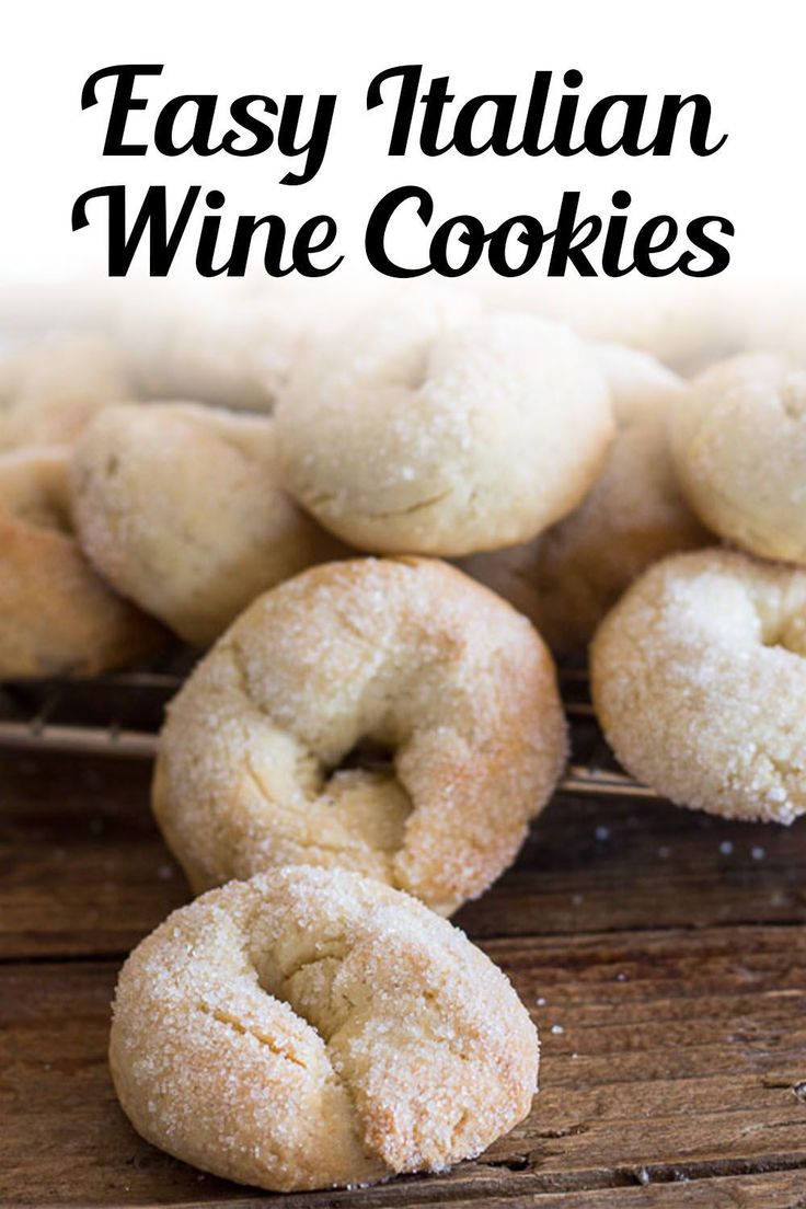 small white cookies sitting on top of a wooden table with the words italian wine cookies above them