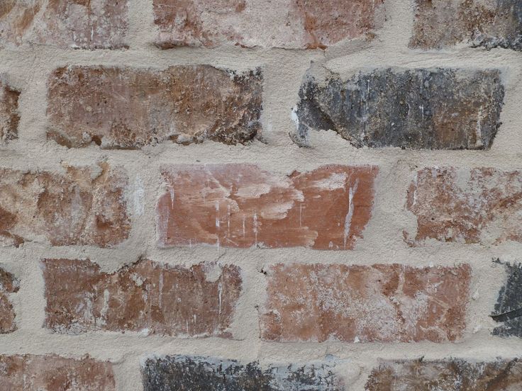 a brick wall that has been painted brown and white