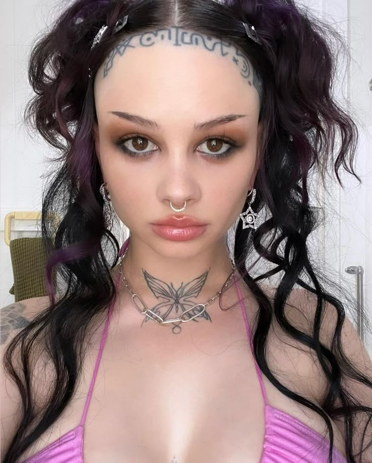 a woman with tattoos on her neck and chest