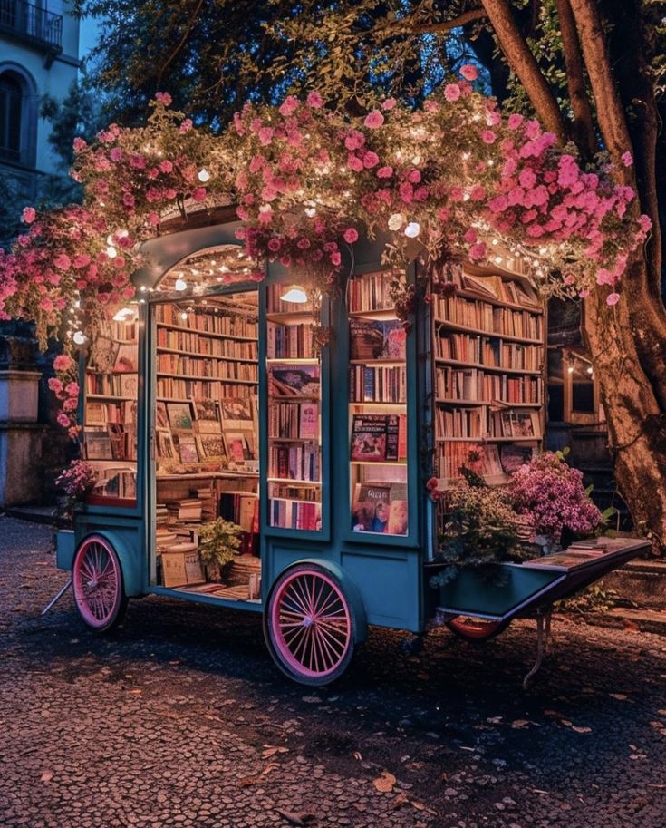 an old fashioned book cart is decorated with flowers and bookshelves for the library