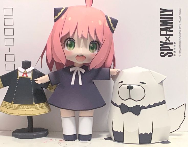 two dolls are standing next to each other near a dog and cat figurine