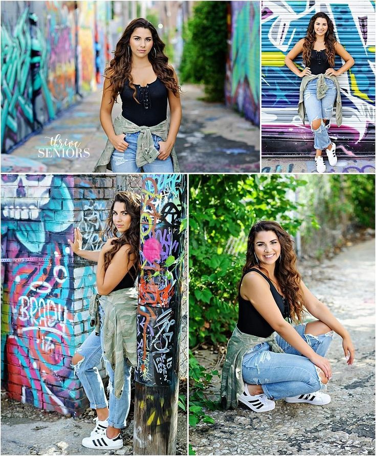 a woman posing in front of graffiti covered walls