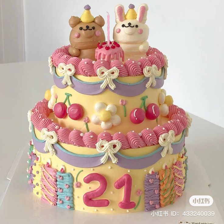 a three tiered cake decorated with pink, yellow and purple frosting has two small bears on top