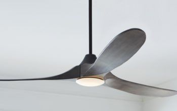 a ceiling fan that is hanging from the ceiling in a room with white walls and flooring