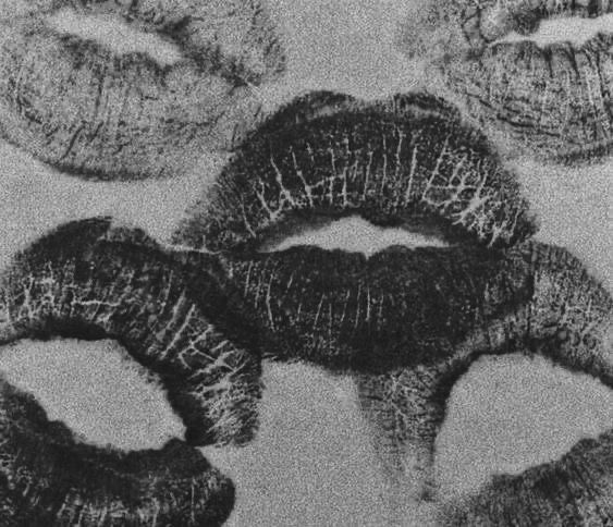 black and white photograph of lipsticks in the shape of lips with their mouths open