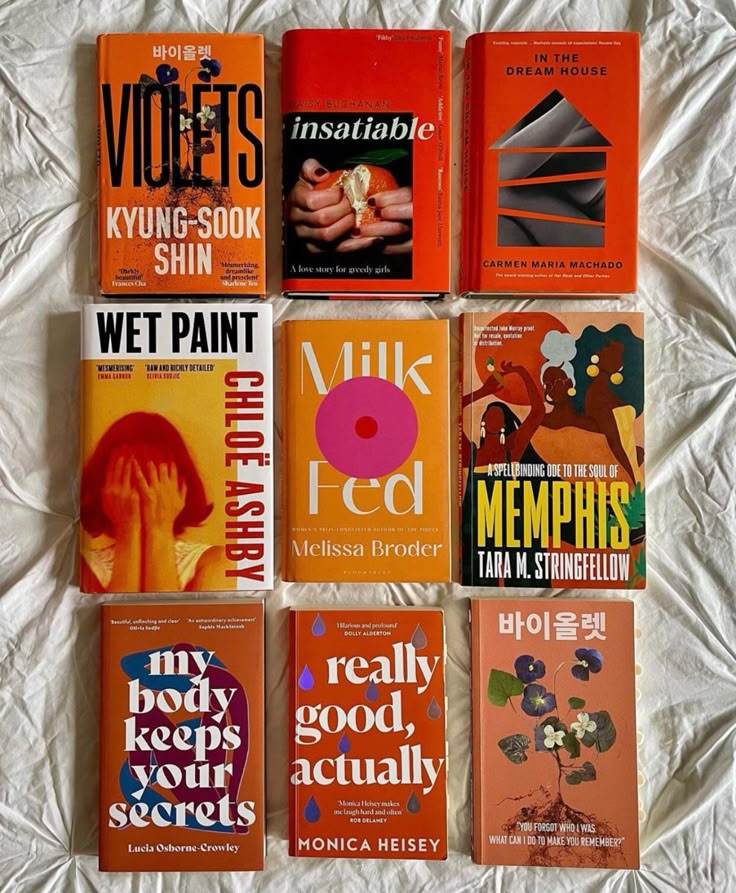 there are many books on the bed together, all in different colors and font choices