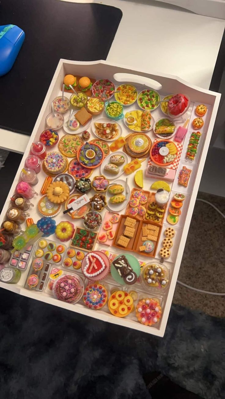 a box filled with lots of different types of buttons on top of a black table