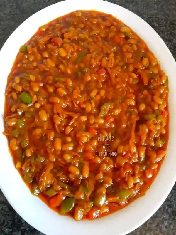 a white plate topped with beans and vegetables