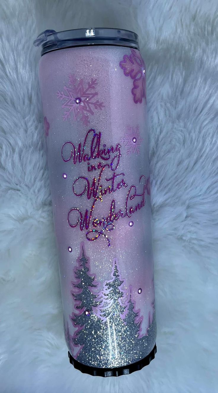 a purple and silver tumbler with snowflakes on it that says, merry winter wonderland