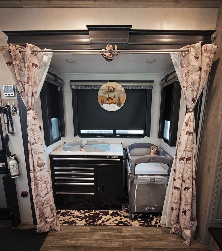 the interior of an rv with curtains and furniture