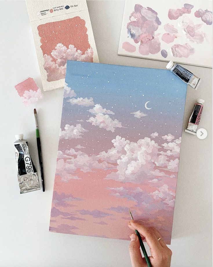 someone is painting clouds in the sky with watercolors and pastel pencils