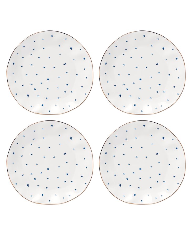 four white plates with blue speckles on them