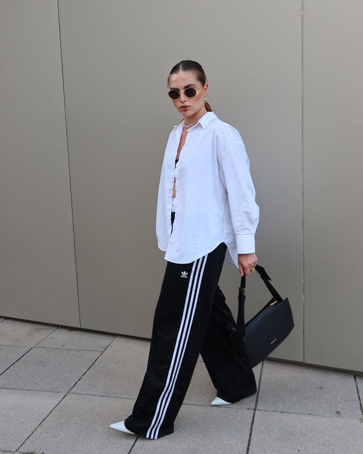 Black Pants Outfit Street Style, Jogger And Shirt Outfit, Contrast Pants Outfit, Black And White Track Pants Outfit, Sport Classic Style Outfit, Athleisure Outfits Office, Track Suit Pants Outfits, Wide Leg Adidas Pants Outfit, White And Black Outfits For Women