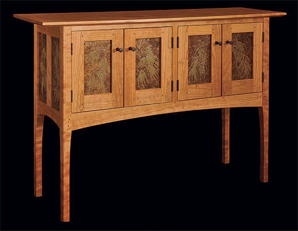 a wooden sideboard with glass doors on the top and bottom drawers inlaided with leaves