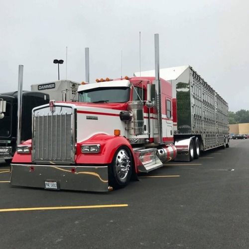 two semi trucks parked in a parking lot