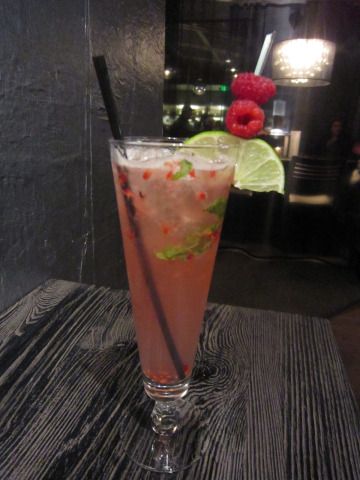 a tall glass filled with liquid and garnish