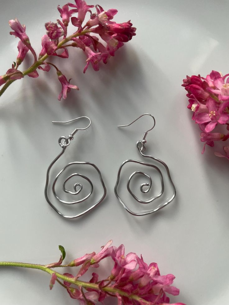 Gorgeous handmade wire wrap swirl earrings. Earrings are on hypoallergenic hooks. Perfect for any occasion. Happy to custom and make to preferred size ⭐️ Wire Earrings Handmade Artful Home, Wire Wrapped Swirl Earrings As Gift, Wire Wrapped Swirl Earrings For Gift, Spiral Wire Wrapped Silver-plated Earrings, Wire Wrapped Spiral Earrings In Silver Plated Wire, Wire Wrapped Swirl Earrings For Jewelry Making, Spiral Wire Earrings With Ear Wire, Spiral Wire Wrapped Silver Plated Earrings, Spiral Silver Plated Wire Earrings As Gift