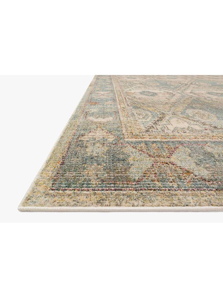 an area rug with various colors and patterns on the floor, including blue, green, beige