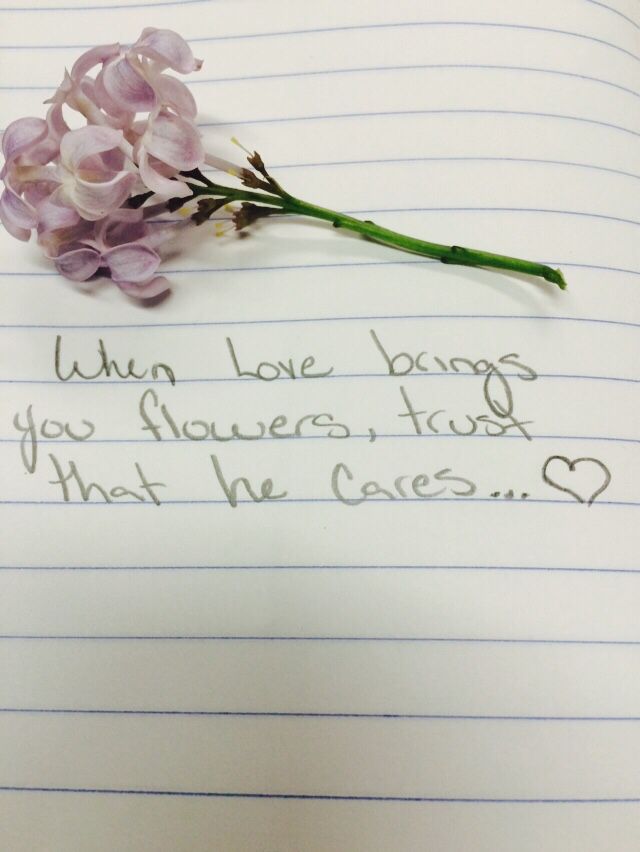 a piece of paper with writing on it next to a purple flower and a pen