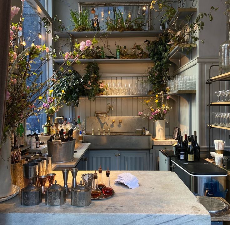 a kitchen filled with lots of pots and pans on top of a counter next to a sink