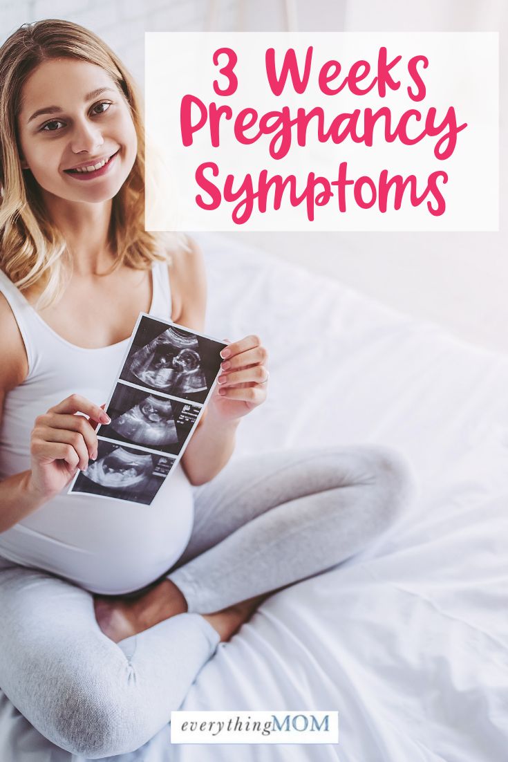 a pregnant woman sitting on her bed with the words 3 weeks pregnant symptoms