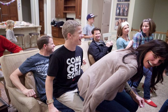 a group of people sitting on couches in a living room next to each other