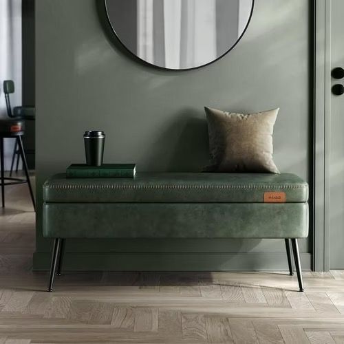 a green bench sitting in front of a mirror