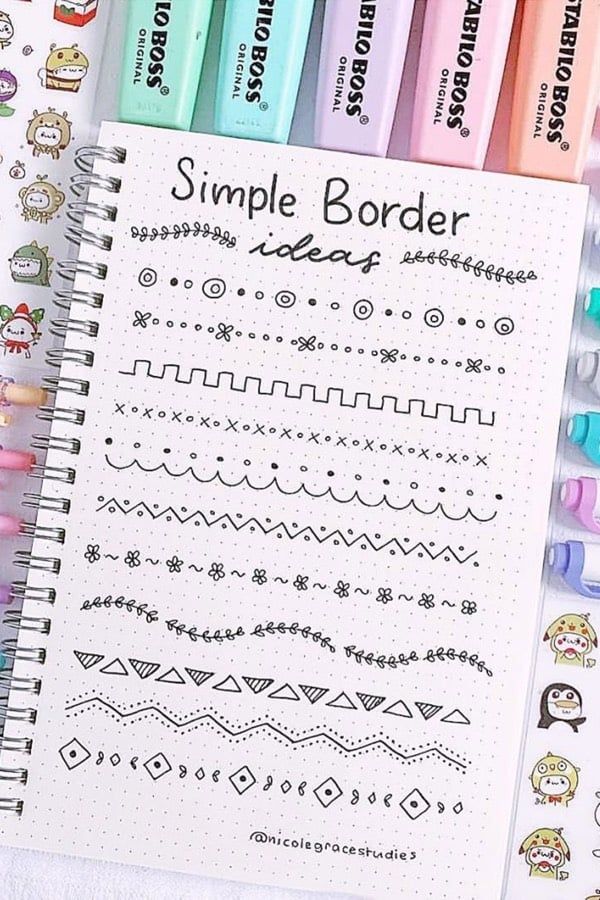 a notebook with some writing on it next to markers and pens that say simple border