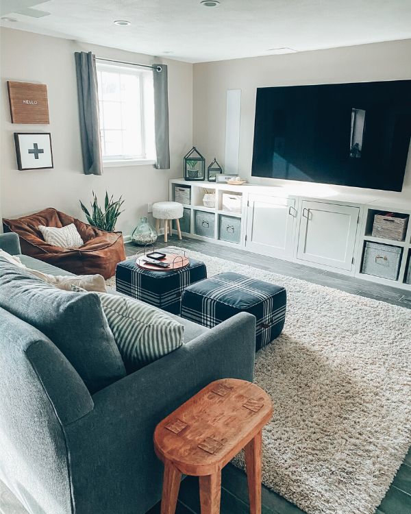 a living room filled with furniture and a flat screen tv mounted to the side of a wall