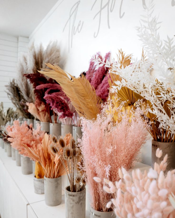 several vases filled with different types of flowers