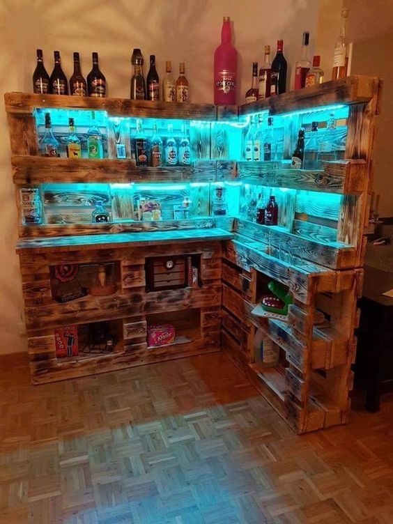 the shelves are made out of pallets with bottles on them