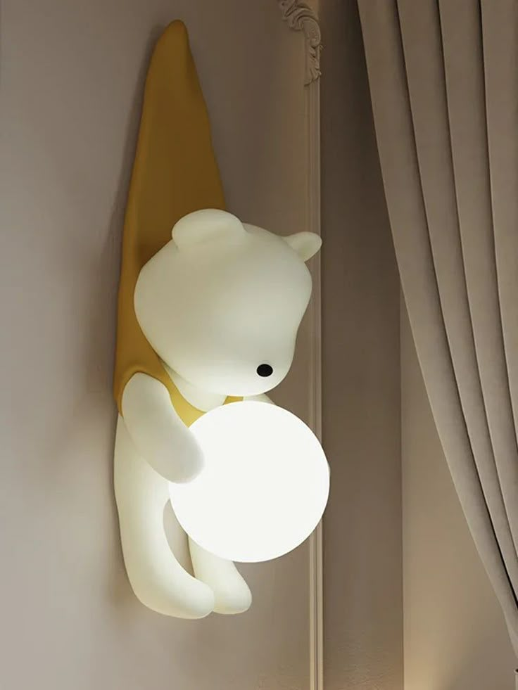 a lamp that is on the side of a wall next to a teddy bear and surfboard