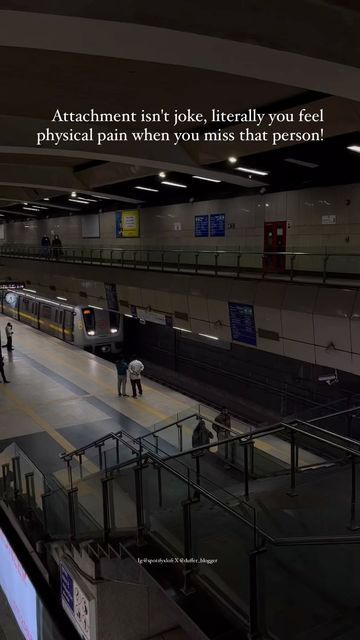 a subway station with people standing on the platform