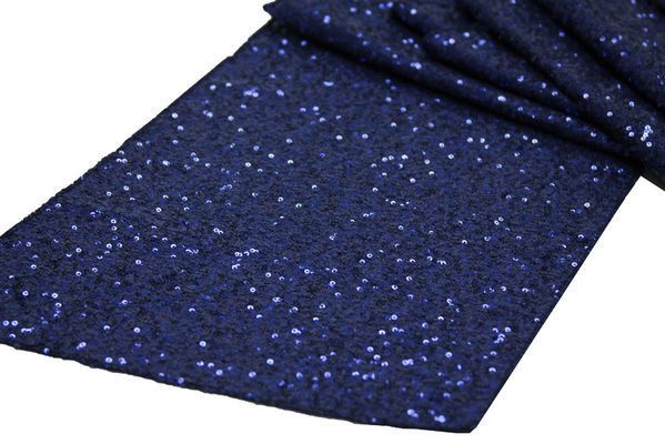 a blue tie that is laying on top of a white surface with lots of small speckles